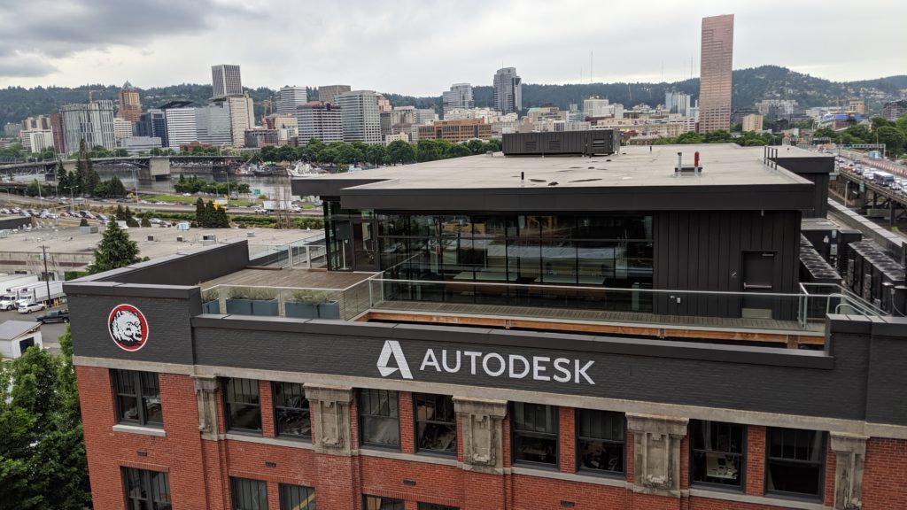 View of the Autodesk logo at the top of the historic Towne Storage building with a view to the Downtown Portland skyline.
